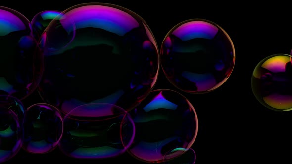 Soap bubbles floating in dark room