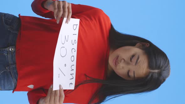 Young Woman Holding Discount Sign