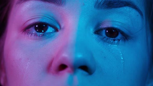 Closeup of Crying Brown Eyes in Ultraviolet Light Shooting of Watery Eye of Young Woman Shooting of