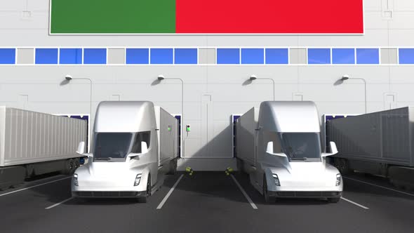 Electric Trucks at Warehouse Loading Bay with Flag of PORTUGAL