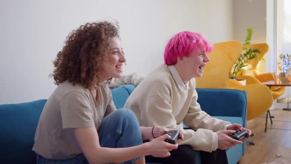 Happy Young People Playing Video Games on Console While Sitting on Couch in Front of Tv