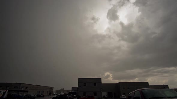 Time lapse of rain storm rolling through industrial area