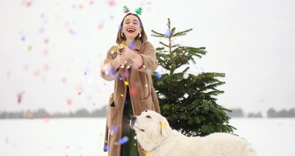 Woman Celebrating New Year Having Fun Shooting Confetti Outdoors