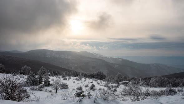 Mists and snowfall over the snow-covered mountain slopes