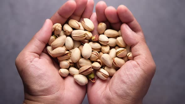 Pistachios Nut on Palm of Man Hand Top Down 