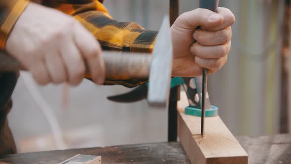 Carpentry - a Man Woodworker Cutting Out the Recess on the Wooden Block