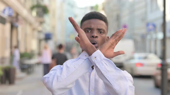 Portrait of African Man Showing No Sign By Arm Gesture