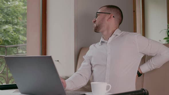 A Young Man Has a Backache at a Sedentary Job