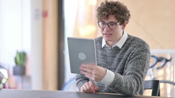 Online Video Chat on Tablet By Young Man at Work