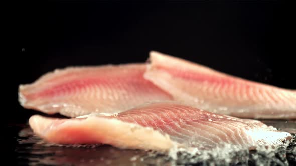 Fish Fillets Fall on a Wet Table with Splashes