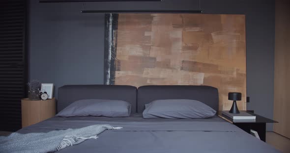The Modern Minimalist Bedroom with Black and Gray Tone Large Paintings and Wood