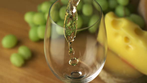 Pouring white wine into glass, Slow Motion