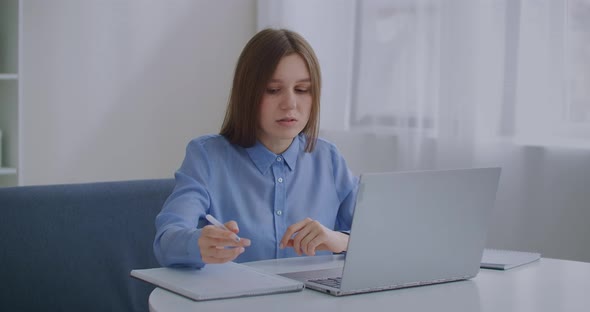 Middle-aged Woman Is Talking Online By Video Call on Notebook, Sitting at Home, Modern Technology of