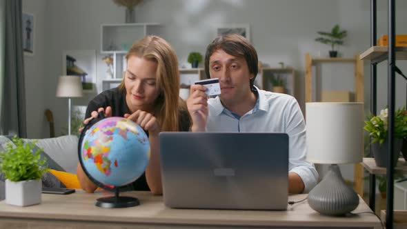 Young Couple Buying Tickets Online