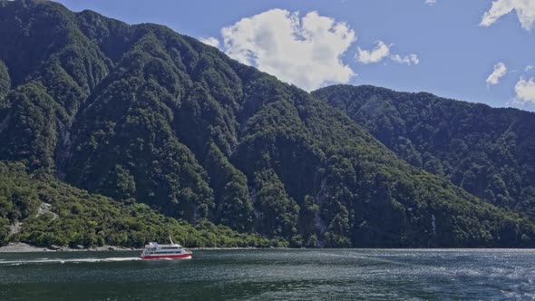 Luxury Cruise Ship Travelling At Milford Sound (Piopiotahi) In Fiordland, New Zealand. - wide shot