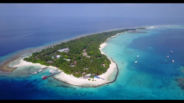 Aerial landscape of marine island beach voyage by blue ocean with clean sandy background of a dayout