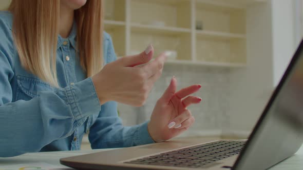 Closeup of Female Hands Communicating with Deaf Sign Language During Video Call