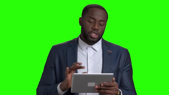 Successful Businessman Using Digital Tablet on Green Screen