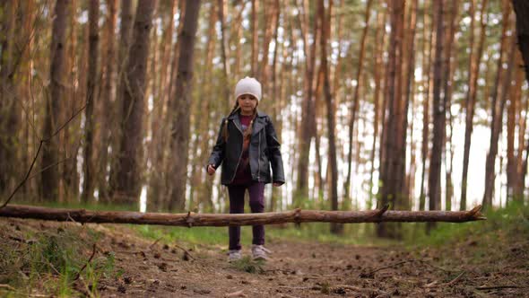 A Person Standing Next To a Tree in a Forest