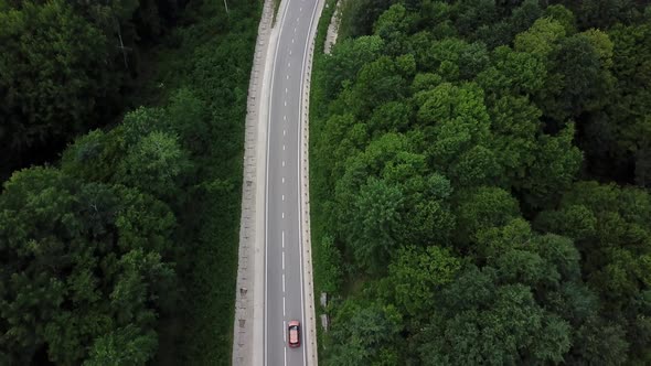 Drone Point of View Tracking Mode Aerial View Flying Over Two Lane Countryside Forest Road with