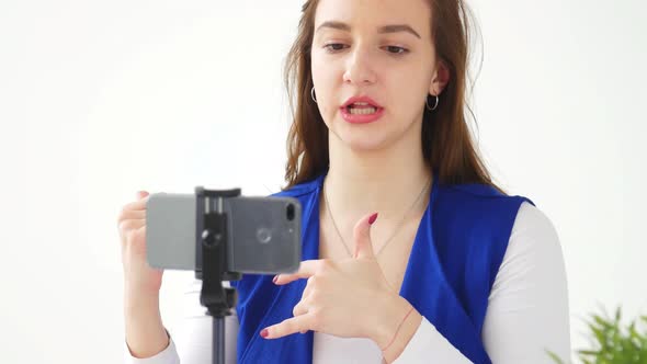 Concept of Blogging and Video Broadcasts. Young Female Blogger Recording Video or Broadcast Live on