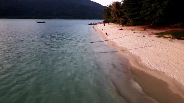 Aerial Low Flying Along Sunset Beach At Koh Lipe. Dolly Forward