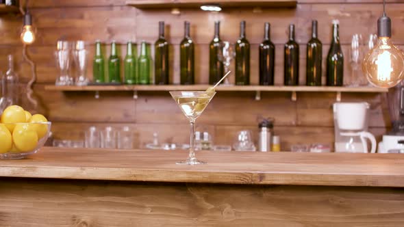 Parallax Shot of a Glass of Martini Beverage on a Bar Background