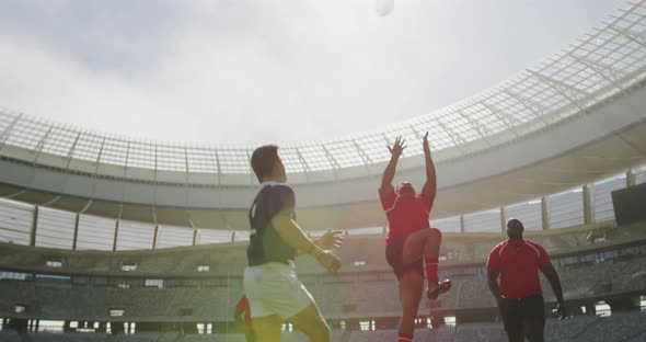 rugby players playing rugby match in stadium