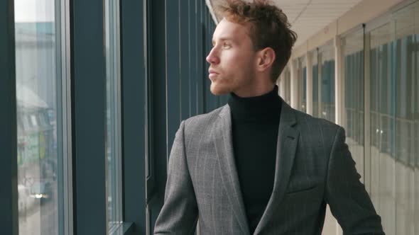 Close-up portrait of a thoughtful man looking into the distance against the city life. Profile of an