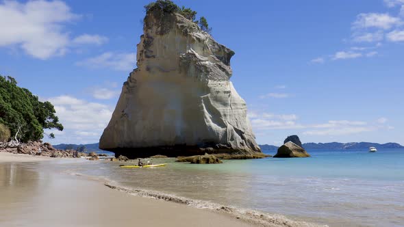 Wide shot of kayaker at Te Hoho rock and Cathedral cove beach. Coromandel Peninsula, Waikato, North