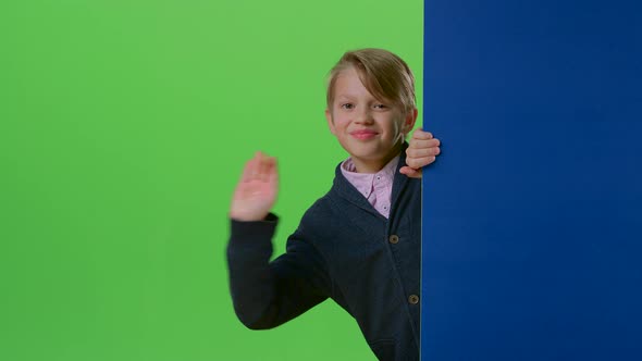 Teen Comes Out From Behind the Walls Waving and Calling To Yourself on a Green Screen