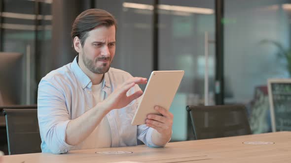 Man Reacting to Loss on Tablet