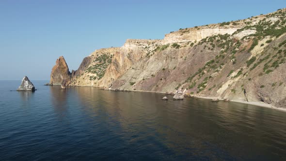 Aerial View From Above on Calm Azure Sea and Volcanic Rocky Shores