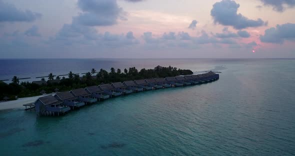 Beautiful birds eye travel shot of a white sandy paradise beach and blue sea background in hi res 