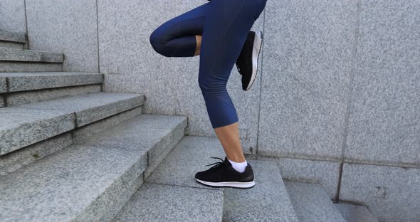 Fitness sports woman running up stairs in city