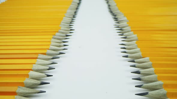 Yellow Pencils Lie Opposite Each Other in a Row