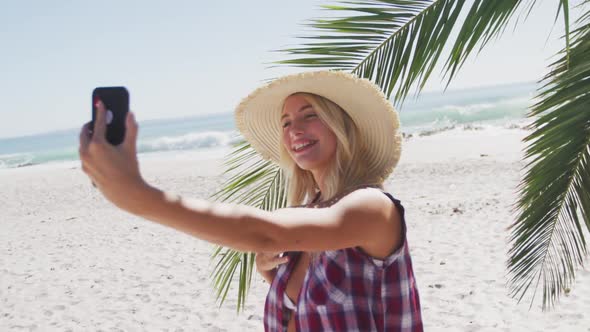 Portrait of a Caucasian woman taking a selfie on the beach