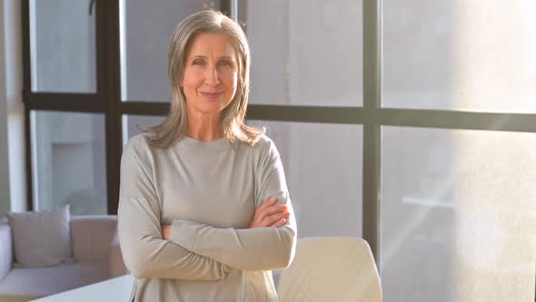 Senior Female Employee Looks at the Camera and Smiles