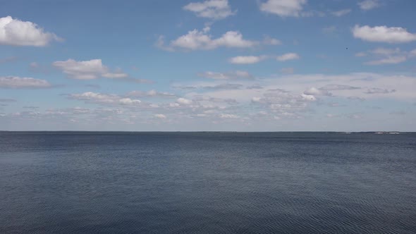 beautiful background of blue sky with clouds on the background of sea water