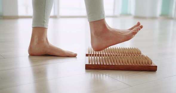 Women Feet on a Sadhu Board Doing Relaxation Exercisecloseup