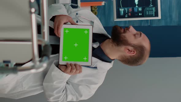 Vertical Video Doctor with Horizontal Green Screen on Tablet Talking to Patient