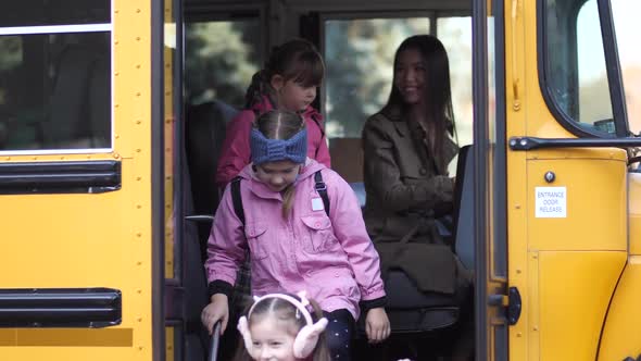 Cute Little Schoolchildren Getting Off School Bus