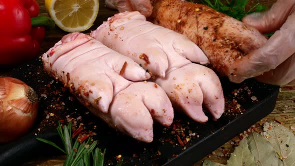 Chef Rubbing Piece of Pork Legs with Savoury Spices and Seasoning for Roasting