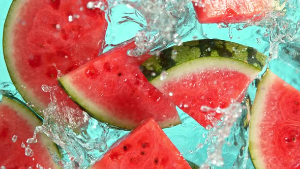 Super Slow Motion Shot of Falling Fresh Watermelon Slices Into Water at 1000Fps