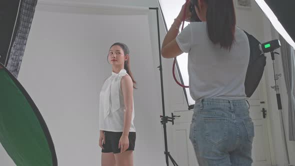 Behind The Scenes On Photo Shoot: Beautiful Asian Model Poses For A Photographer