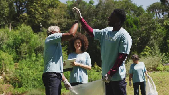 Happy family cleaning a garden together