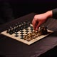 Footage of two men in suits playing chess in a dark room, the game just started - VideoHive Item for Sale