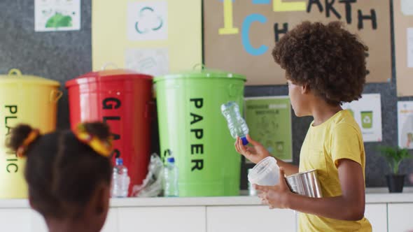 Diverse schoolboy making presentation for his colleagues how to recycle plastic trash