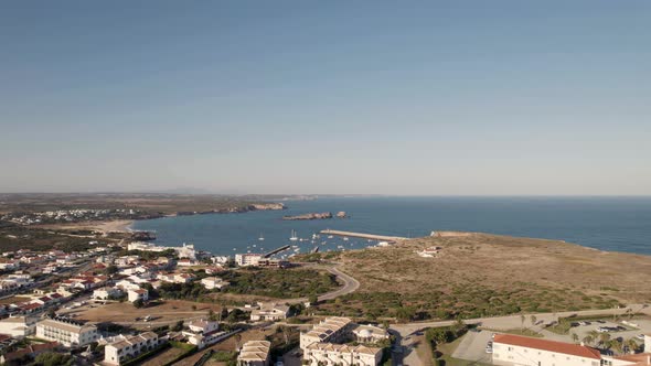 Drone shot overlooking at Porto de Pesca da Baleeira port and Praia da Baleeira beach Sagres