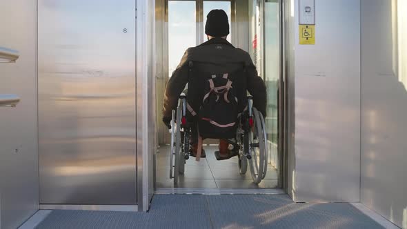 Man Getting Into Elevator for Disabled People